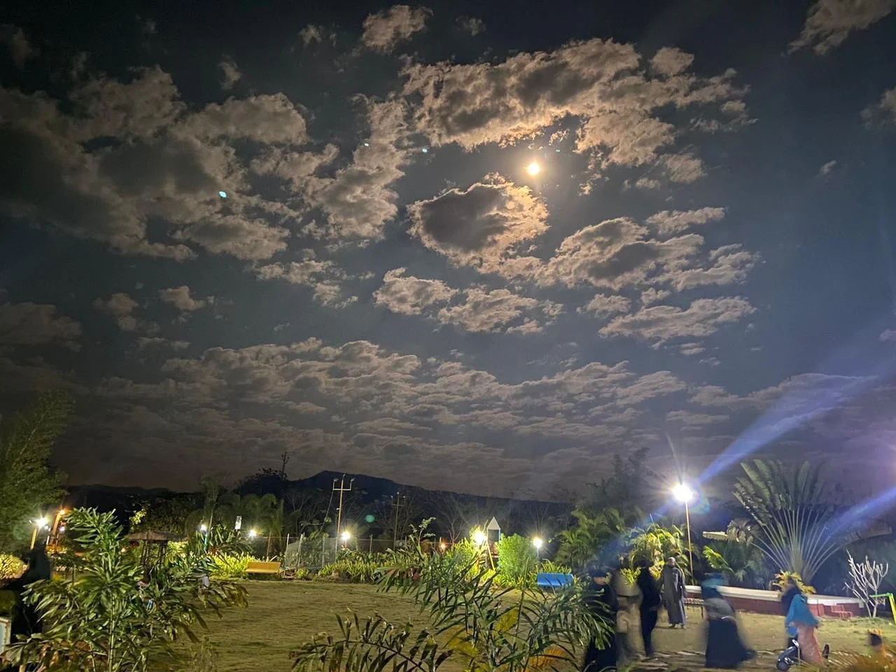 Moonlit sky above the illuminated grounds